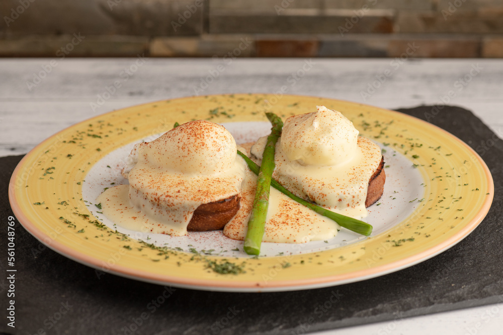Benedict eggs in a yellow plate