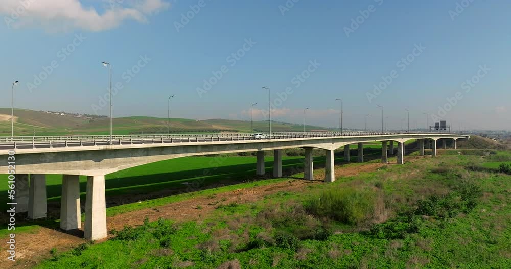Day traffic on a countryside bridge surrounded by lush green landscape
Day traffic on a countryside bridge surrounded by lush green landscape