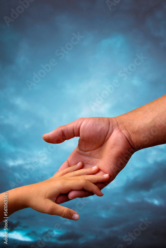 father and son touching hands © Visualmind