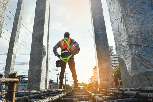  worker wearing equipment safety harness and safety line working at high place work at building site concepts of residential building under construction