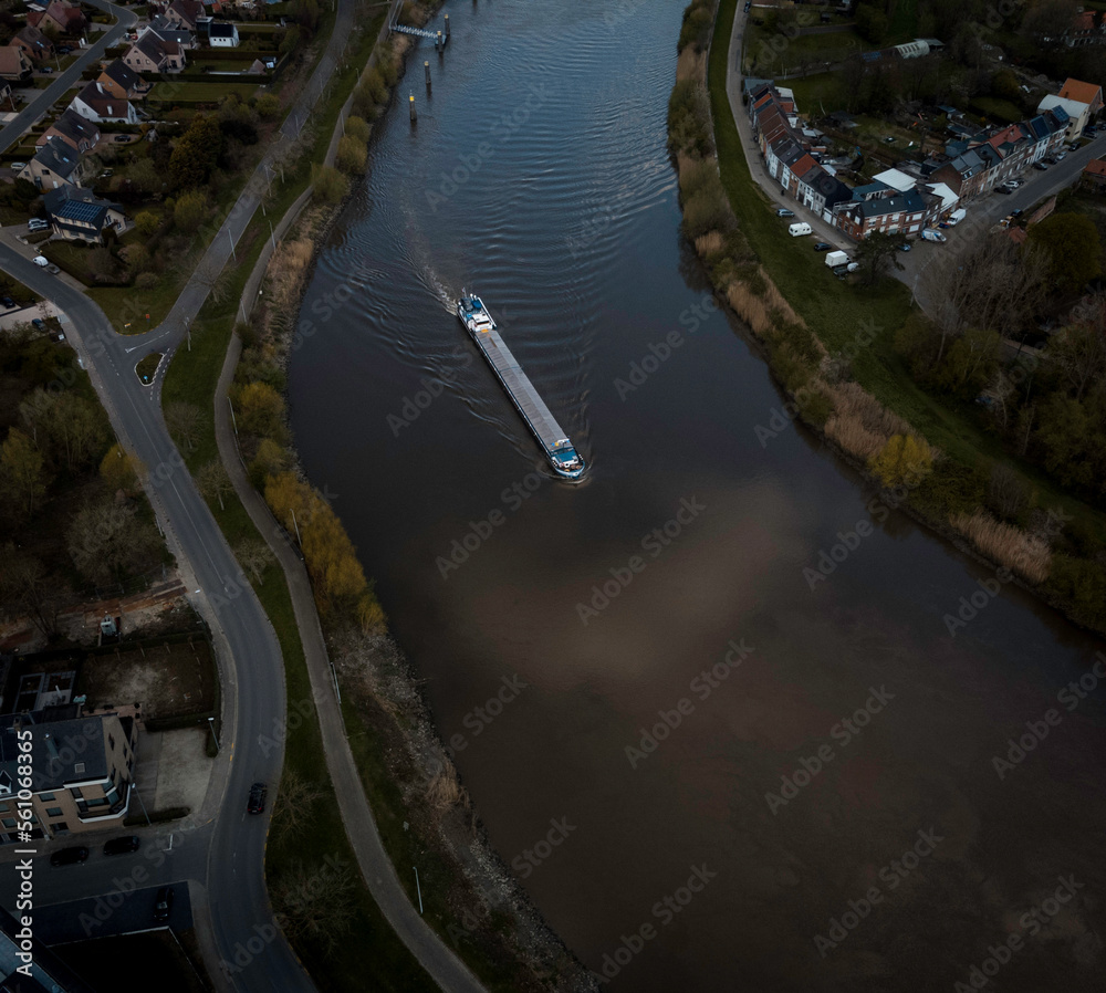 Aerial view of a narrow boat on a river