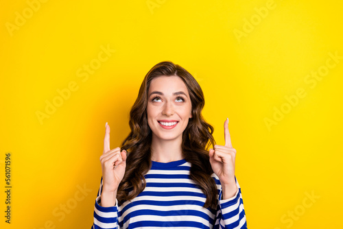 Photo of interested curious young look up directing fingers useful tips empty space opening new shop cheap gifts isolated on yellow color background © deagreez