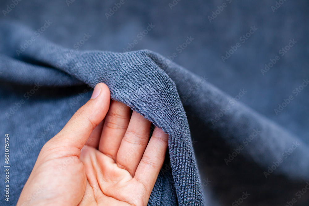 Hand holding the fabric. Women touch the fabric soft and smooth , Stock