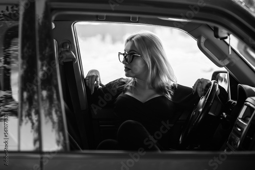 Stylish European blonde woman in car, modern sexy lady, automobile concept
