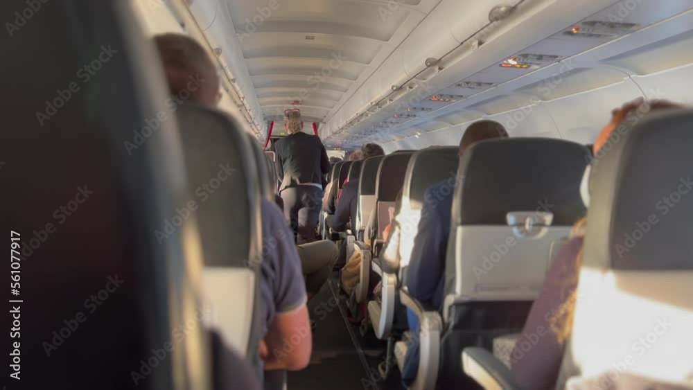 Plane corridor aisle. Passenger seated inside airplane traveling in flight Plane corridor aisle. Passenger seated inside airplane traveling in flight
