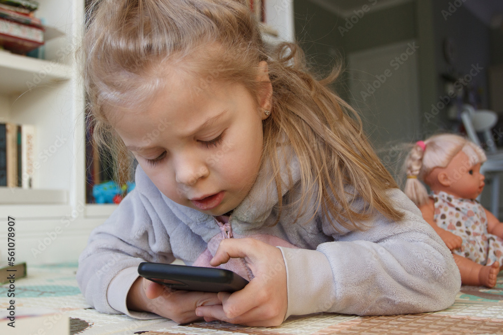 Little cute child holds a smartphone with a green screen. Concept of education online