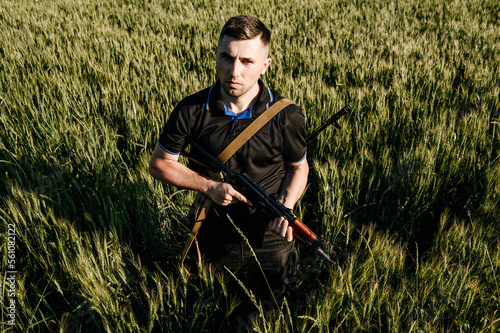 The man in the field with a machine gun, Ukrainian men prepare for the war. photo