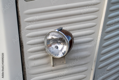 Headlight of an old Citroen H-type corrugated iron panel van