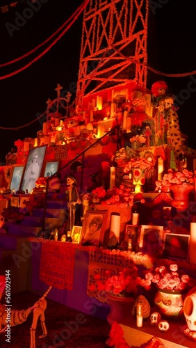Dead altars Mexican culture at night with lighted candles, candles traditional decorations