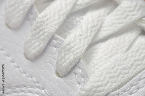 macro of white shoelaces of white leather shoes