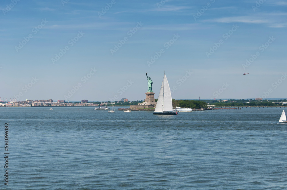 sailboat and statue of liberty new york city