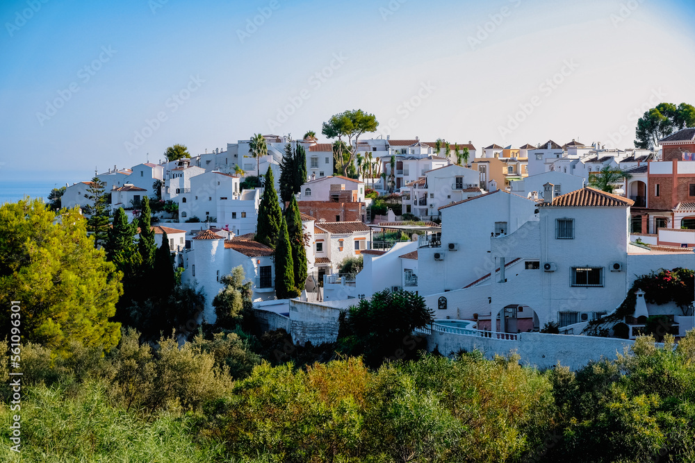 Spanish village on a hill with many white buildigs in Nerja, Spain