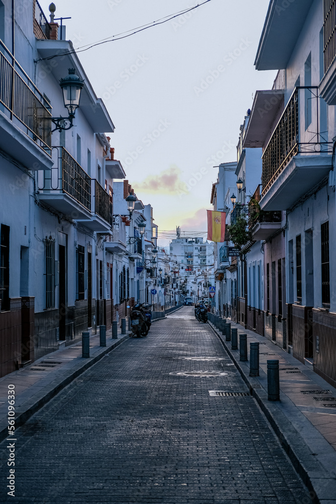 Empty narrow street and typical spanish buildings in Nerja, Spain
