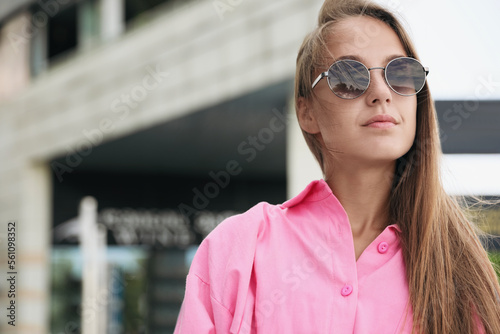 Beautiful young woman in stylish sunglasses on city street, space for text © New Africa