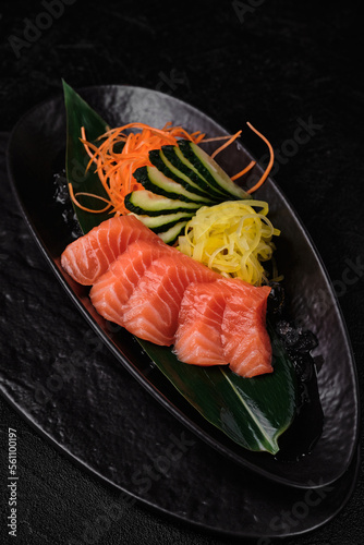 Served tuna sashimi on black background