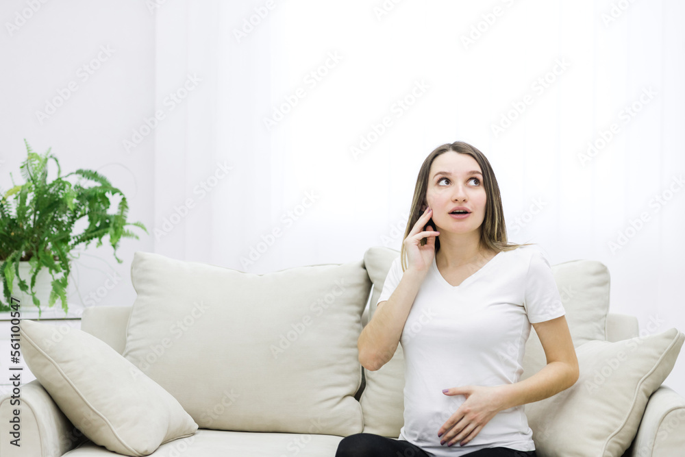Cropped photo of pregnant woman looking somewhere. Cropped photo of pregnant woman looking somewhere.