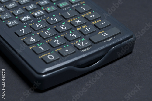 Scientific calculator isolated on black paper background
