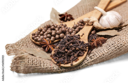 Dry tea with spices in wooden spoons,