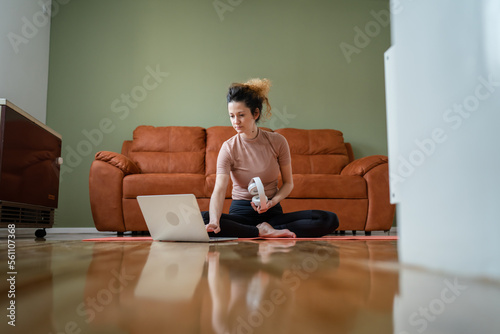 Woman sit at home use laptop prepare for online training