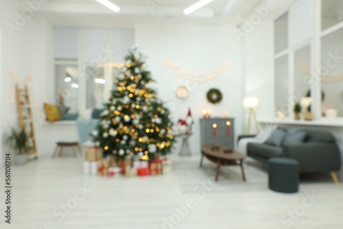 Blurred view of decorated Christmas tree in living room. Interior design © New Africa