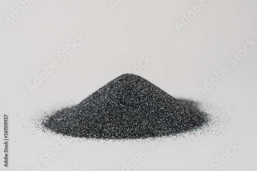Silicon carbide powder close-up isolated on white background. Silicon carbide abrasive grit for restore stones to original flatness and leveling sharpening stones. photo