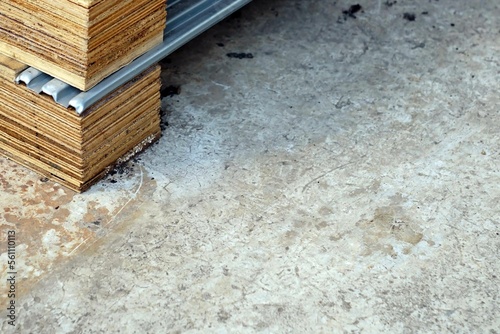 A wooden block arrange of a pallet on cement floor.