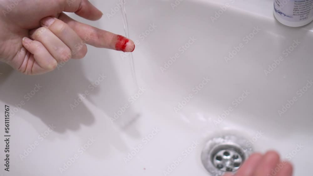 Stockvideo Hand with blood clean under running tap in sink. Bloody