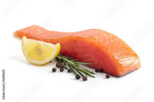 Salmon piece with rosemary, lemon, and peppercorn isolated on a white background.