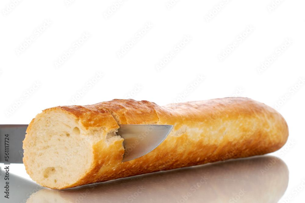 One half of fresh aromatic baguette with metal knife, macro, isolated on white background. One half of fresh aromatic baguette with metal knife, macro, isolated on white background.
