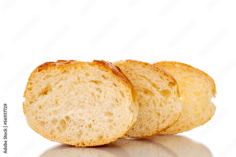 Three slices of fresh aromatic baguette, macro, isolated on white background.