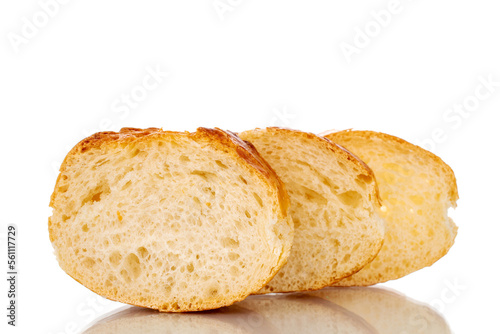 Three slices of fresh aromatic baguette, macro, isolated on white background.