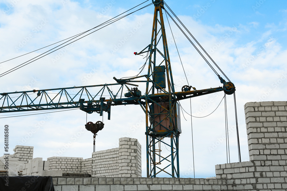 Fototapeta premium Construction site with tower crane near unfinished building