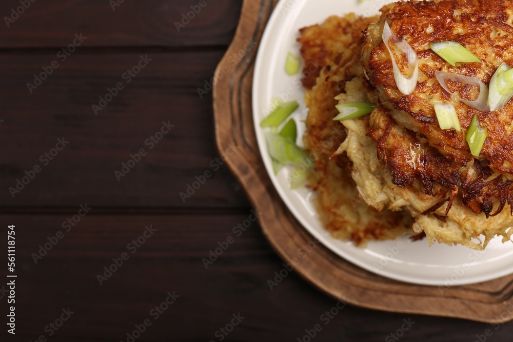 Tasty parsnip cutlets with green onion on wooden table, top view. Space for text Tasty parsnip cutlets with green onion on wooden table, top view. Space for text