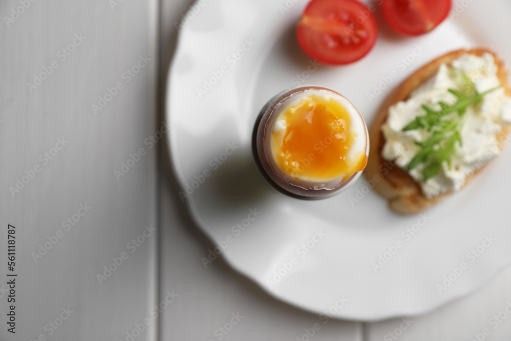 Breakfast with soft boiled egg on white wooden table, top view. Space for text Breakfast with soft boiled egg on white wooden table, top view. Space for text