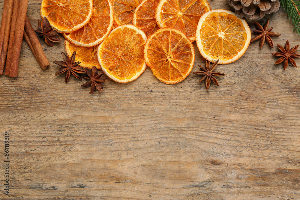Dry orange slices, cinnamon sticks and anise stars on wooden table, flat lay with space for text Dry orange slices, cinnamon sticks and anise stars on wooden table, flat lay with space for text