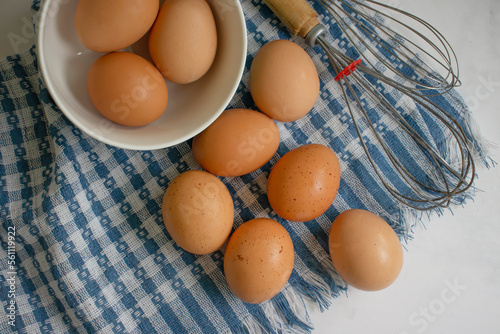 Fresh eggs in a bowl on a light background