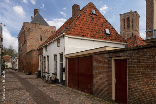 Former town hall and prison with the church tower in the Dutch historic fortified town of Elburg.