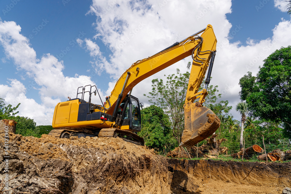 Excavator at earthworks. Construction of a new road. Excavator at earthworks. Construction of a new road.