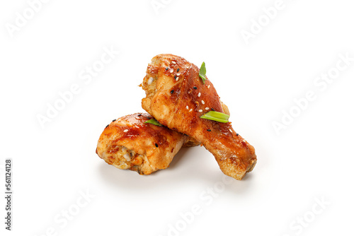 Roasted Baked chicken legs drumsticks, chicken meat with sesame seeds isolated on white background with clipping path, cut out. © Maria