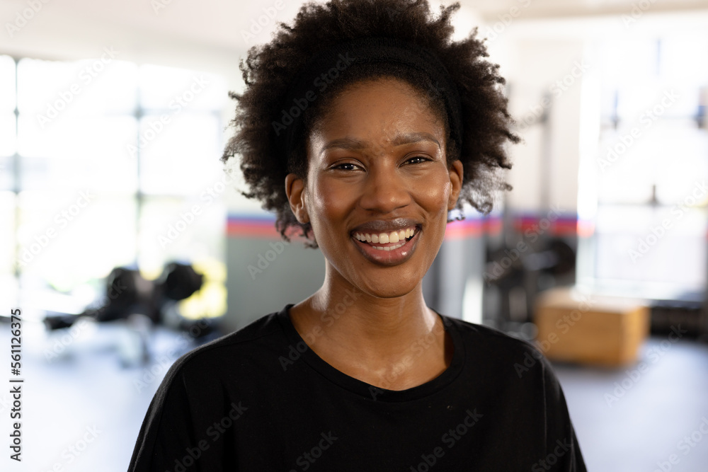 Portrait of happy african american fit woman at gym