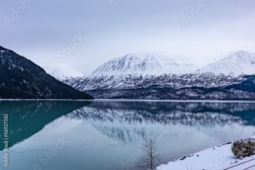 reflecting lake in the foggy Alaskan mountains outside of Seward Alaska in winter snow