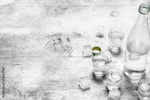 фотографія Vodka in a bottle and ice cubes.