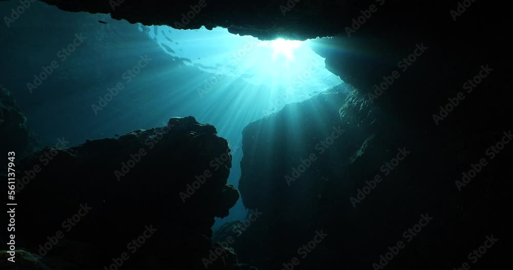 sun rays sun beams and sun shine underwater in cave beautiful light scenery in ocean scuba divers to see