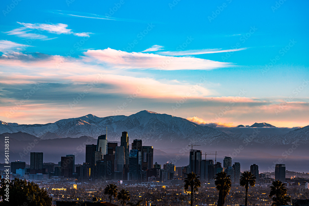 Snow Capped Mountains Sit Behind Los Angeles Skyline