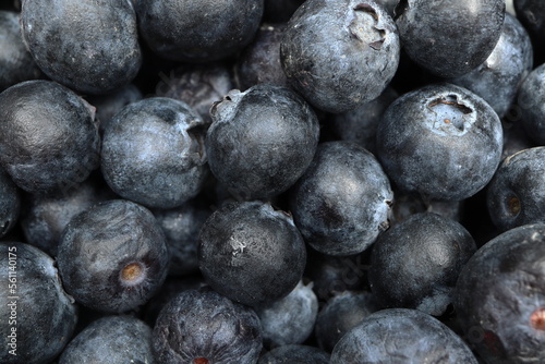 Close-up macro shot of the blueberries lying on a flat surface.