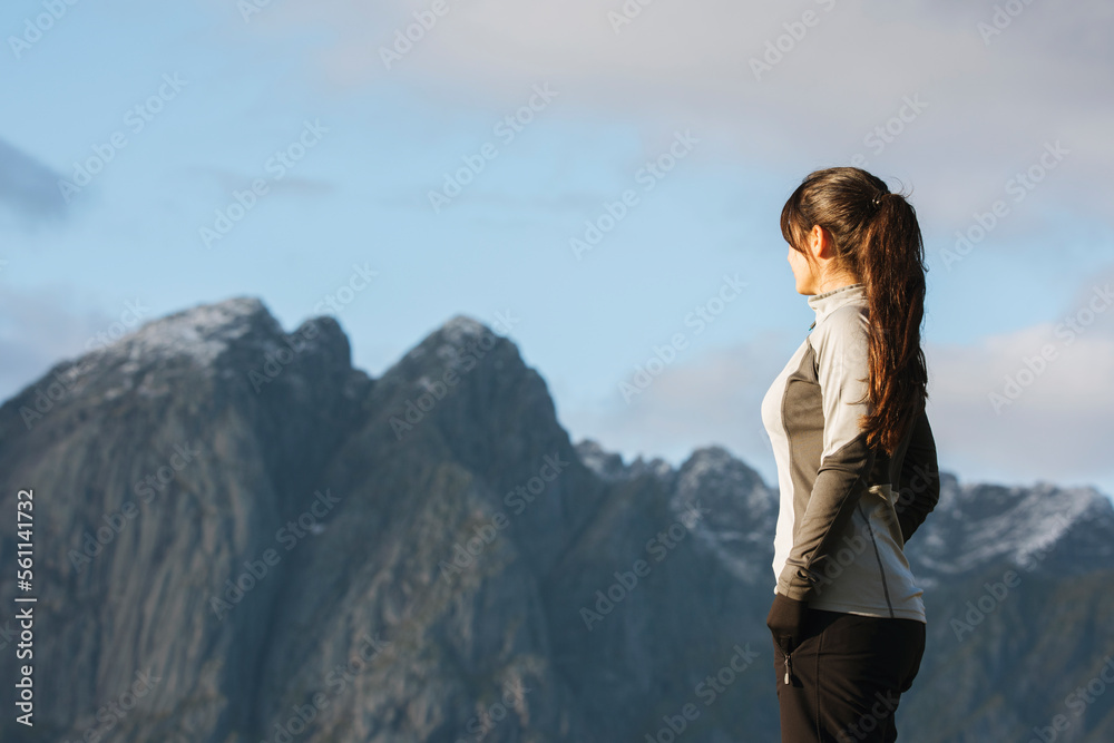 Female hiker looking at mountains in Norway Female hiker looking at mountains in Norway