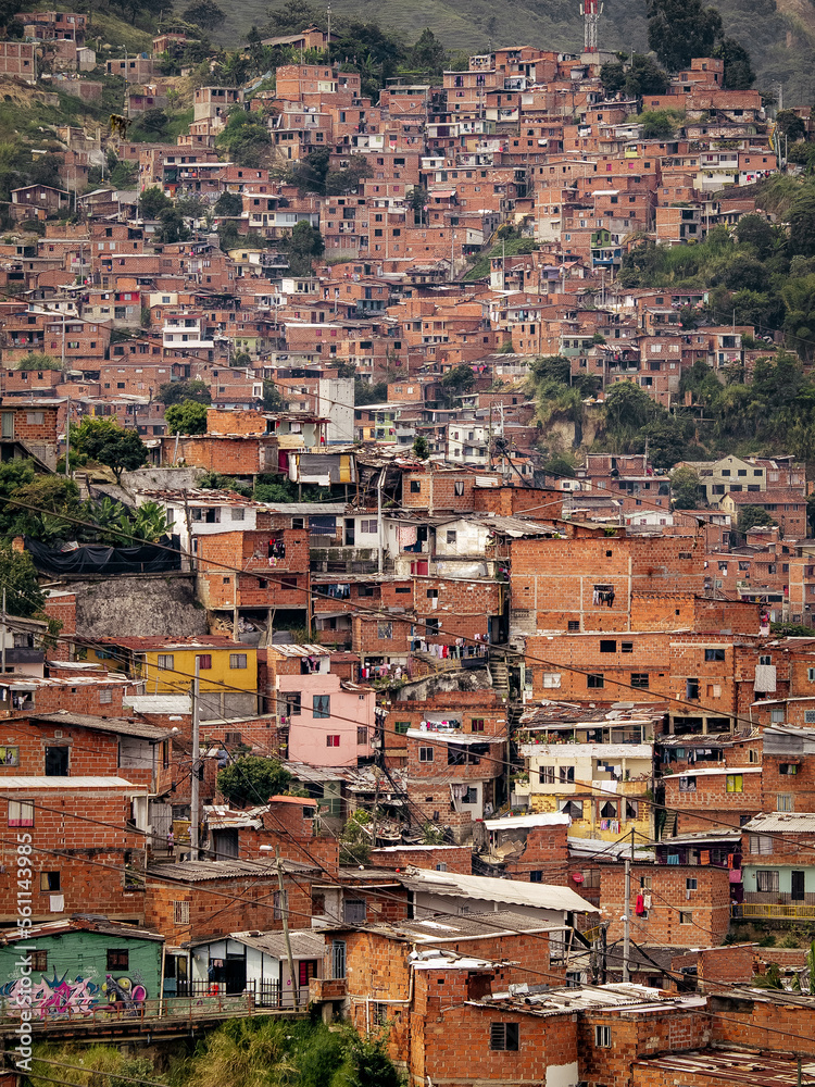The comuna 13 neighborhood in Medellin, Colombia has transformed from a former ghetto to a well-developed area, with stacked houses as a unique feature.