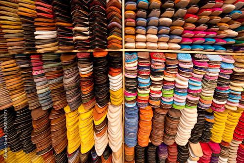 An elaborate and colorful wall of shoes at a leather shop next to the famous Chouara leather tannery in Fes el-Bali, Fes, Morocco.