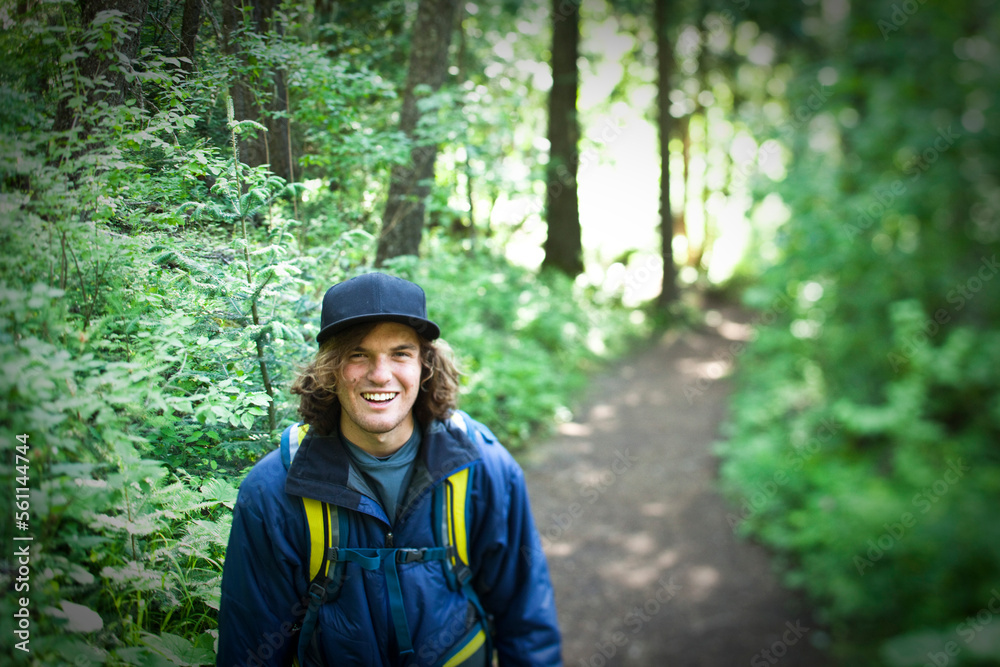 A young man smiles on a hiking trail in Idaho. A young man smiles on a hiking trail in Idaho.