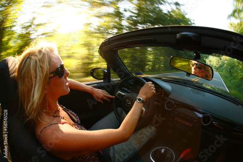Woman out for a summer evening drive in her convertible in South Asheville, NC